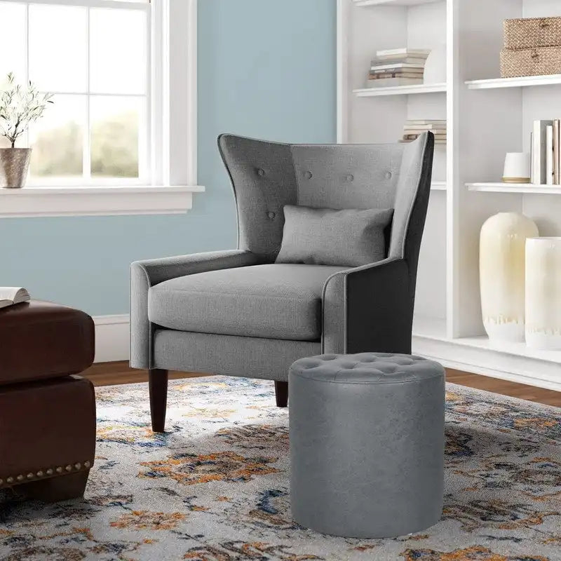Pouffe rond tapissé en simili cuir capitonné