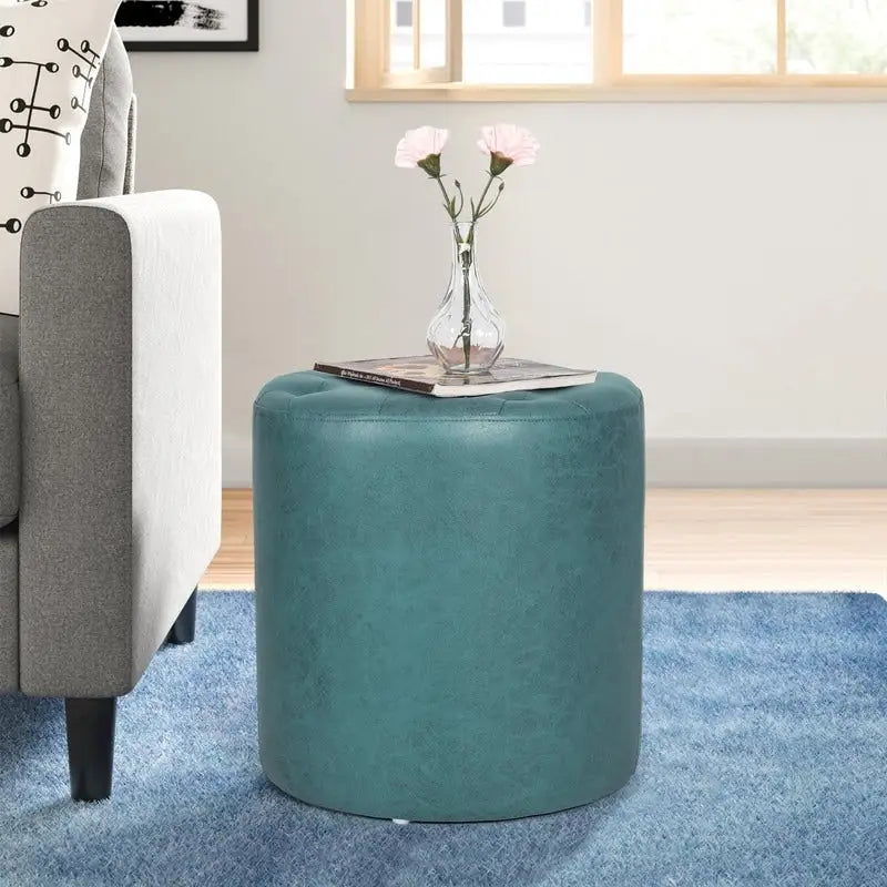 Pouffe rond tapissé en simili cuir capitonné