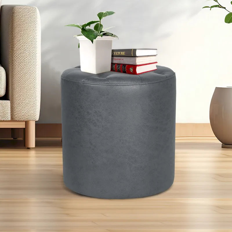 Pouffe rond tapissé en simili cuir capitonné