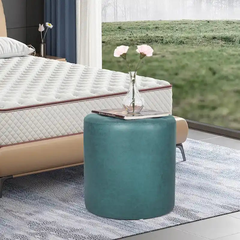 Pouffe rond tapissé en simili cuir capitonné